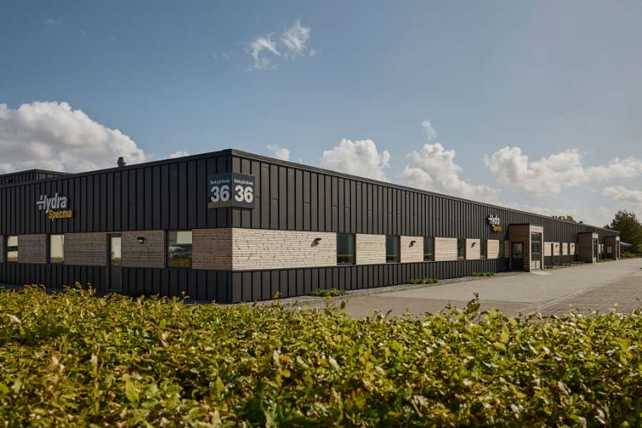 Black steel profiles and warm wood create striking contrasts on headquarters facade, Jernvej 19, 6900 Skjern, Denmark